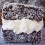 Close up lamington filled with jam and cream.