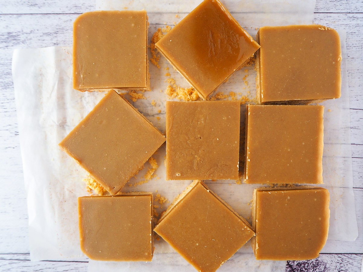 Cut up ginger crunch on baking paper.