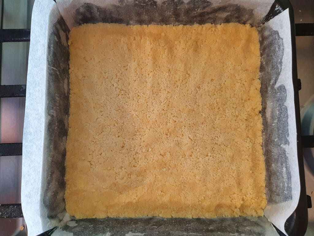 Base flattened down in tin ready to bake.