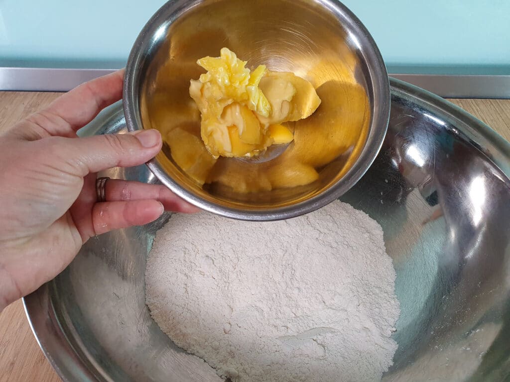 Adding butter to bowl.
