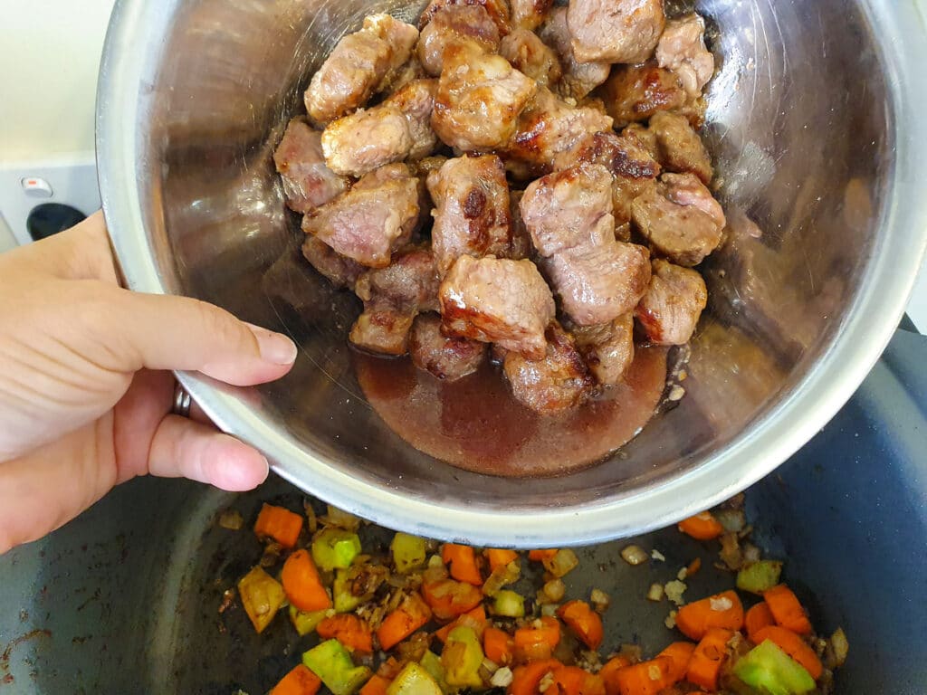 Slow cooker lamb ragu 22 Adding browned lamb to slow cooker.