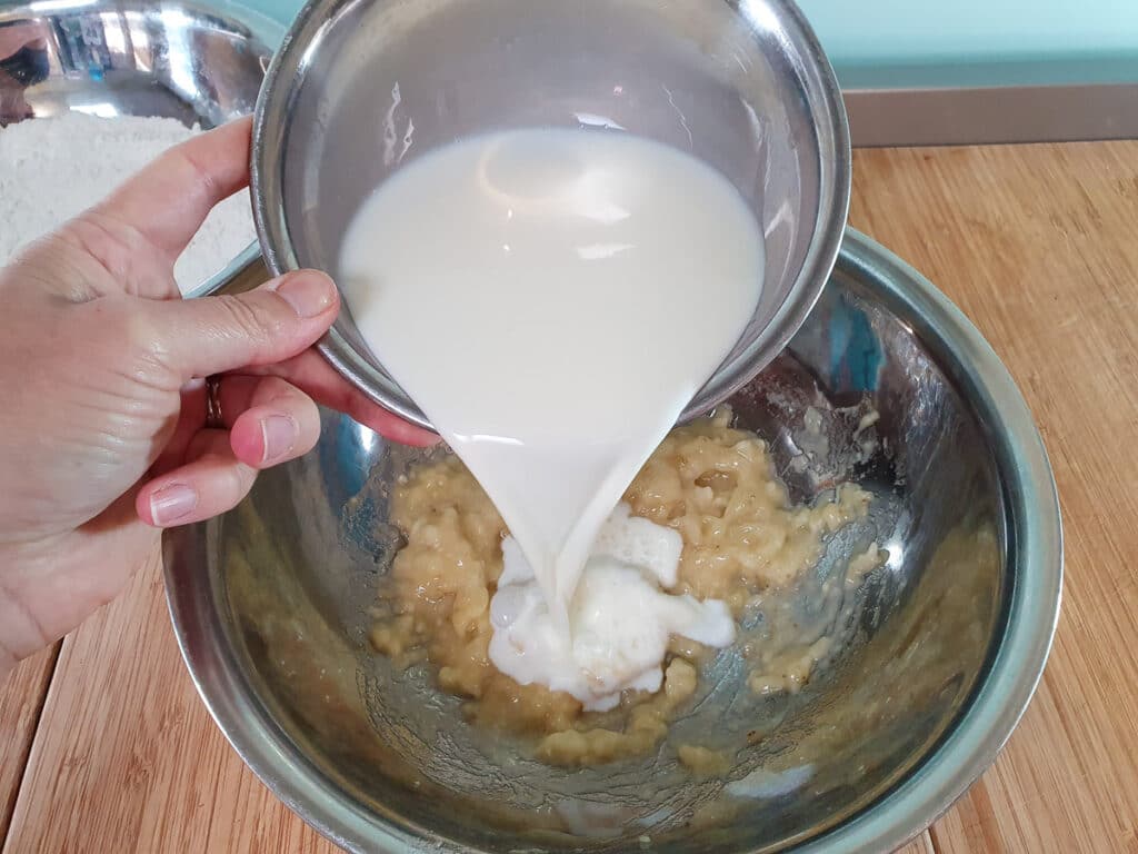 Banana pikelets 8 Adding milk to mashed banana.