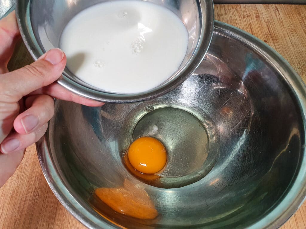 Pikelets 8 Adding milk to egg.