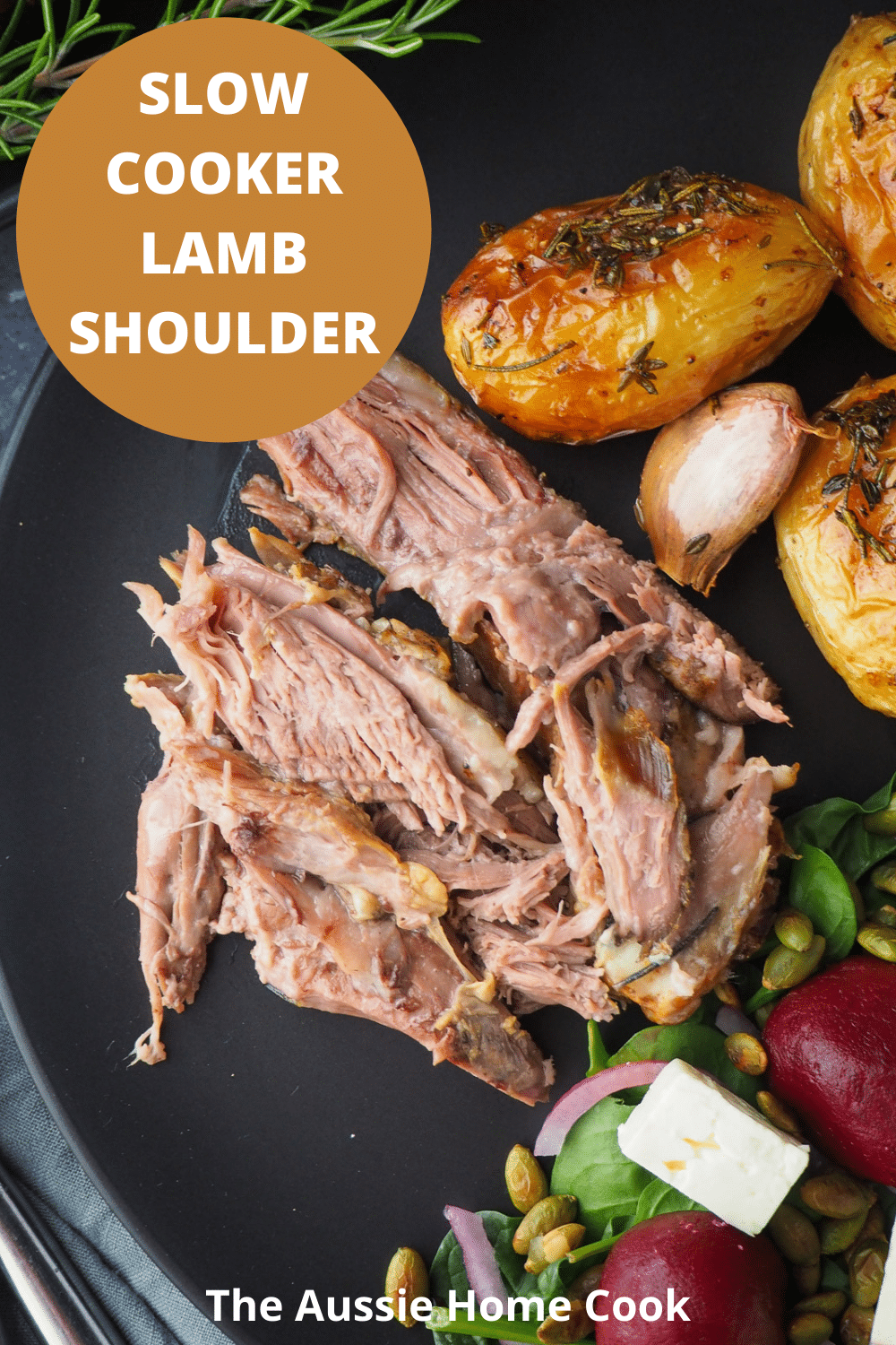 Slow cooker lamb shoulder server on a plat, with roast potatoes and beetroot salad on the side, with text overlay, slow cooker lamb shoulder, The Aussie Home Cook.