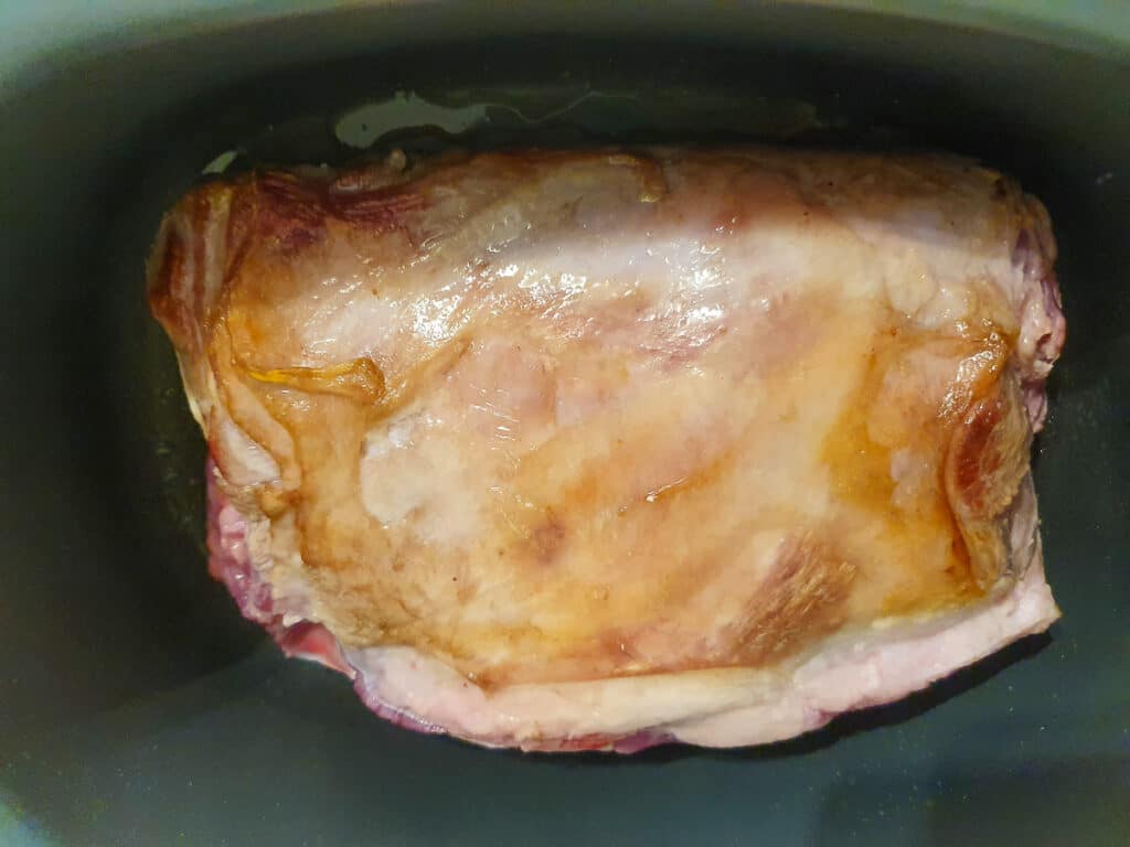Browning the lamb on the bottom side.