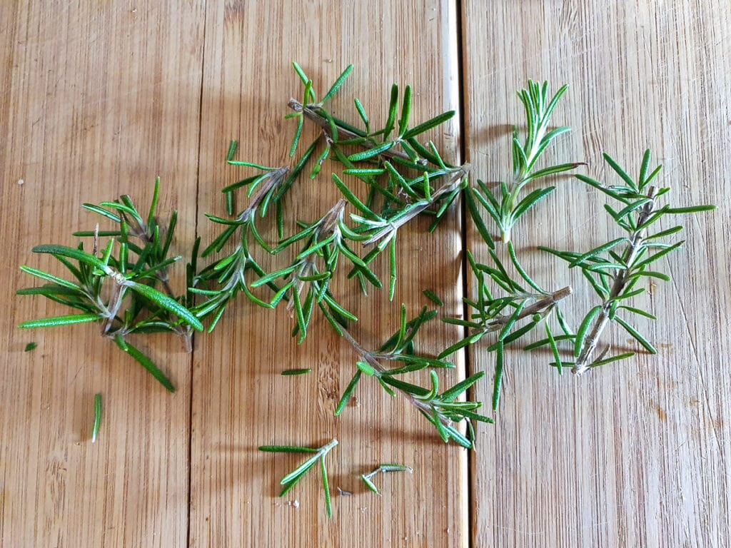 Short sprigs of chopped rosemary, about ¾ inch ish long, ready to insert into lamb.