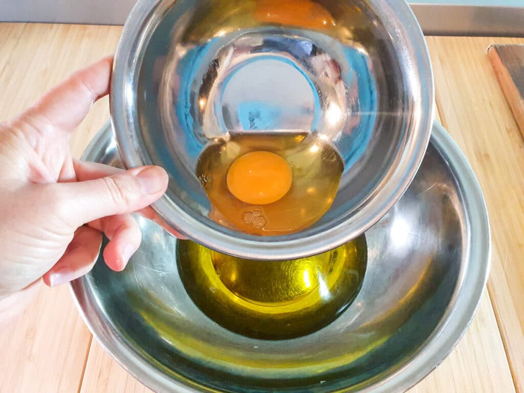 Adding egg to oil.