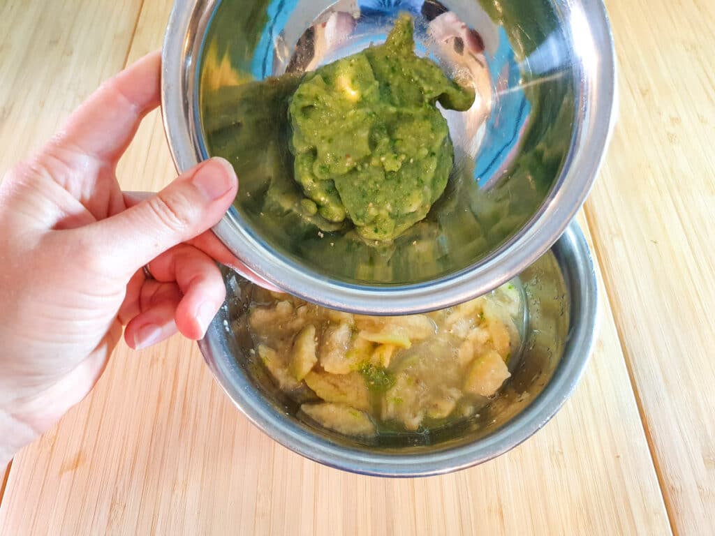 Adding whole blitzed feijoa to mashed feijoa pulp.
