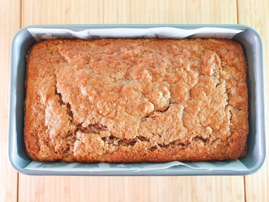 Baked loaf in tin out of the oven.