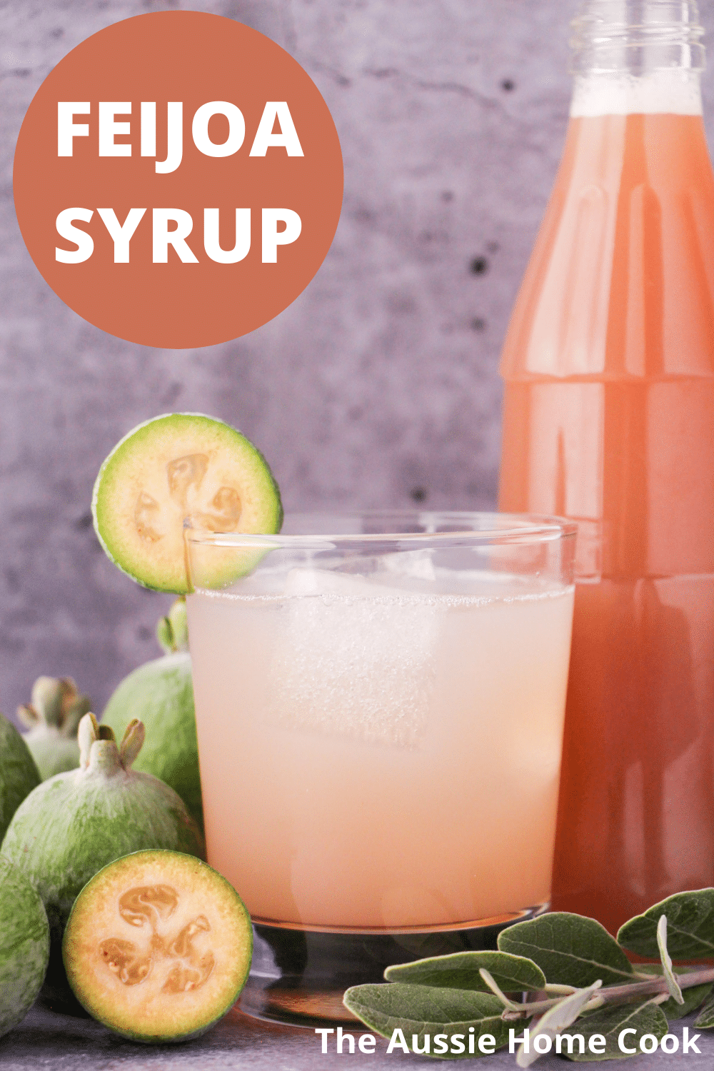 Glass of made up feijoa syrup with ice and fresh feijoa garnish, with bottle of feijoa syrup and fresh feijoas and leaves, with text overlay, feijoa syrup and The Aussie Home Cook.