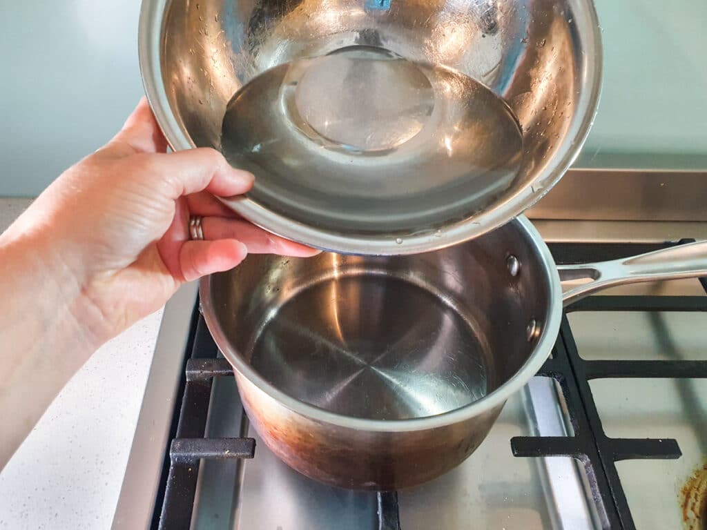 Adding water to pot.