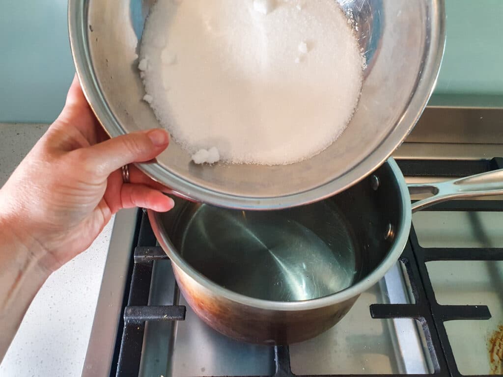 Adding sugar to pot.