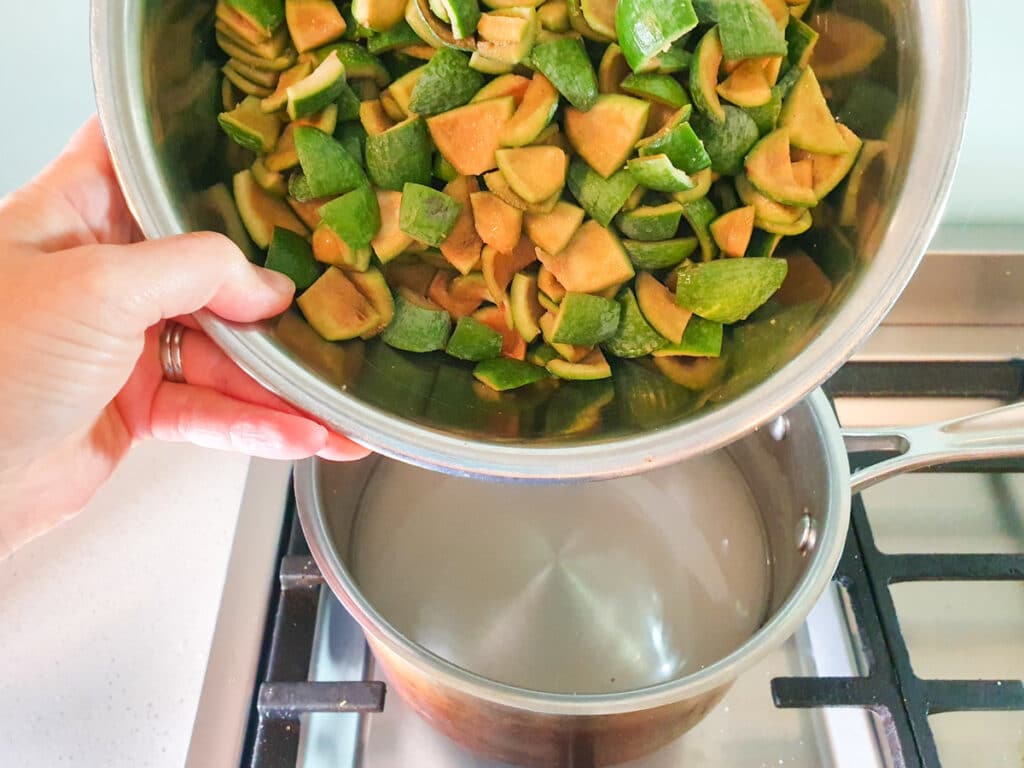 Adding chopped feijoa skins to pot.