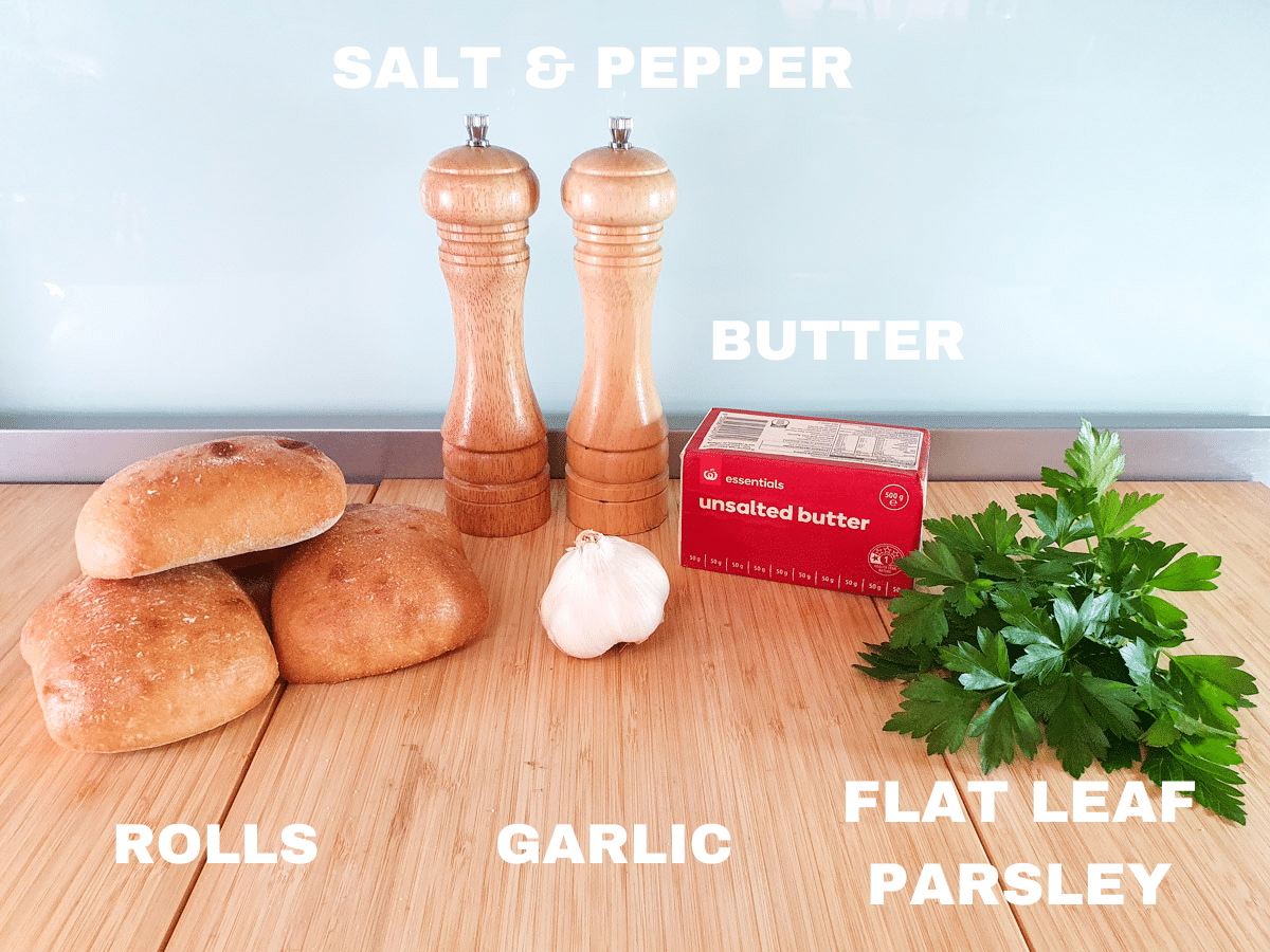 Air fryer garlic bread ingredients, rolls, salt and pepper, garlic cloves, unsalted butter, flat leaf parsley.
