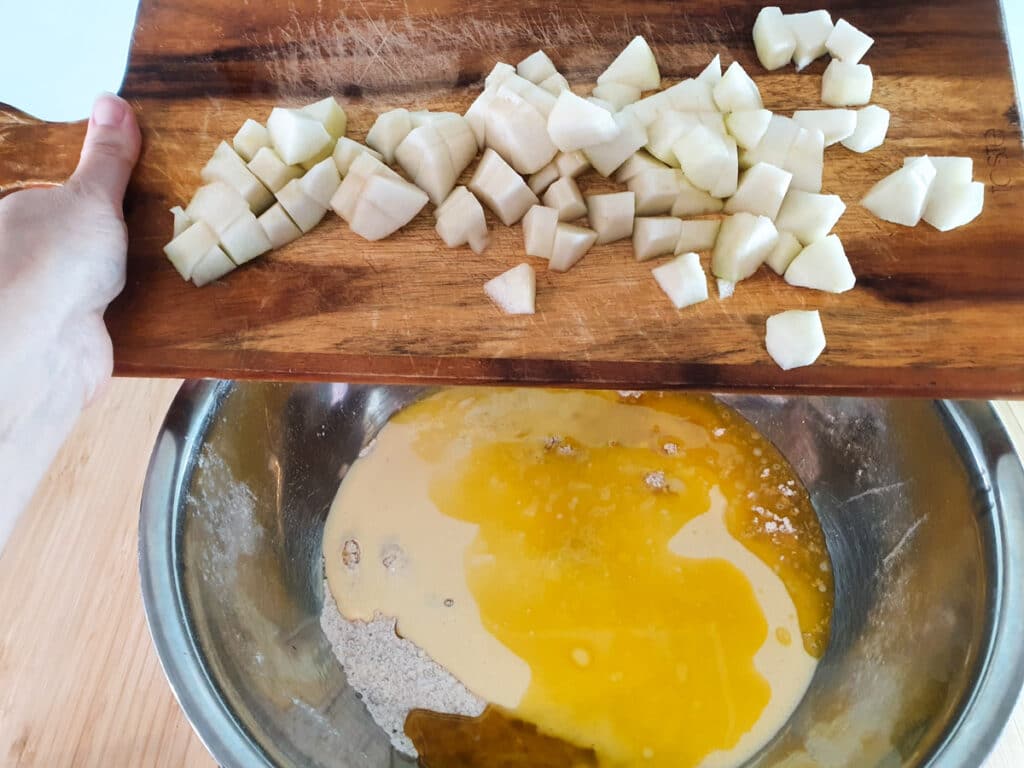 Pear muffins 11 Adding diced pears to muffin mix.