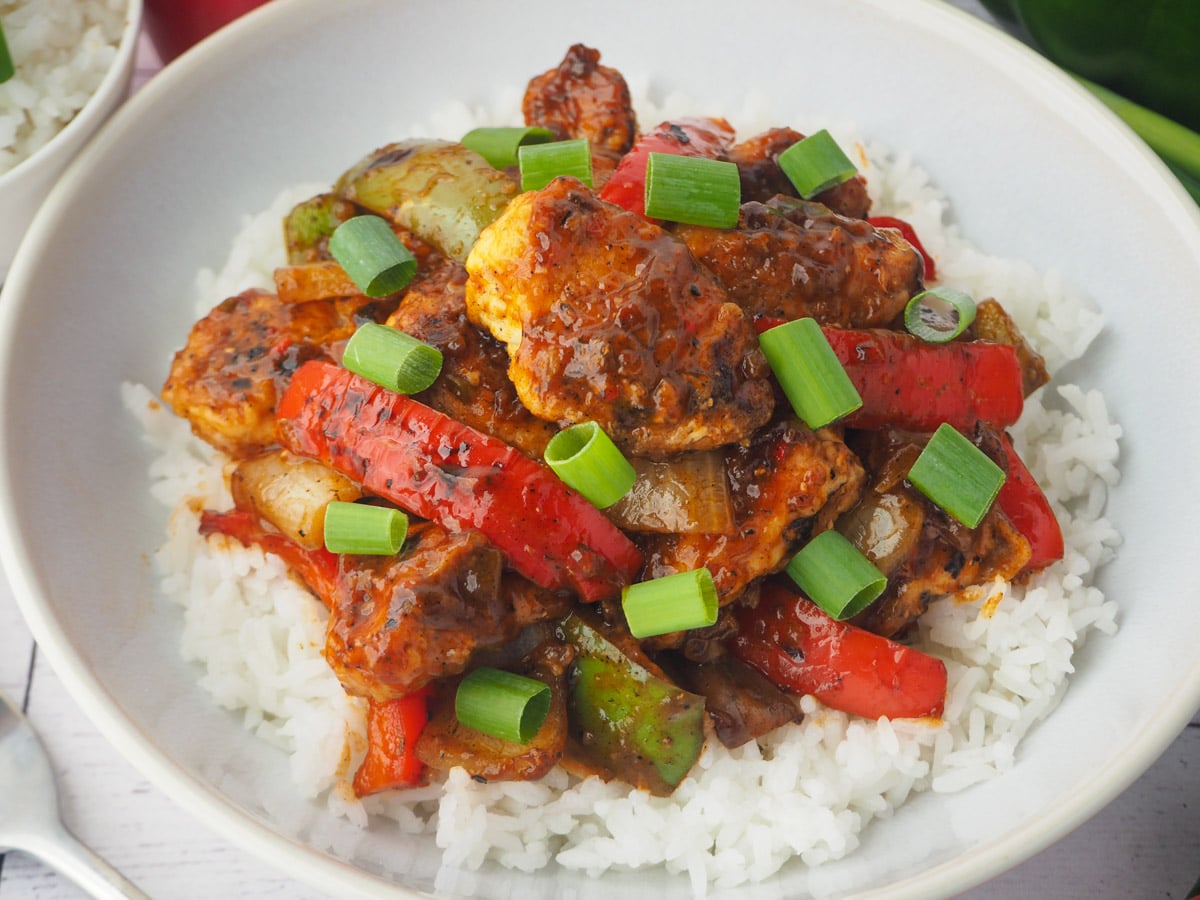 Close up chicken with spring onions.