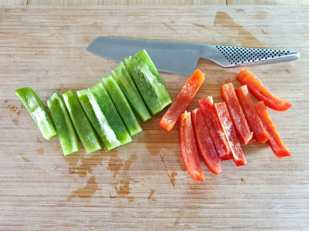 Cutting up the red and green capsicum.