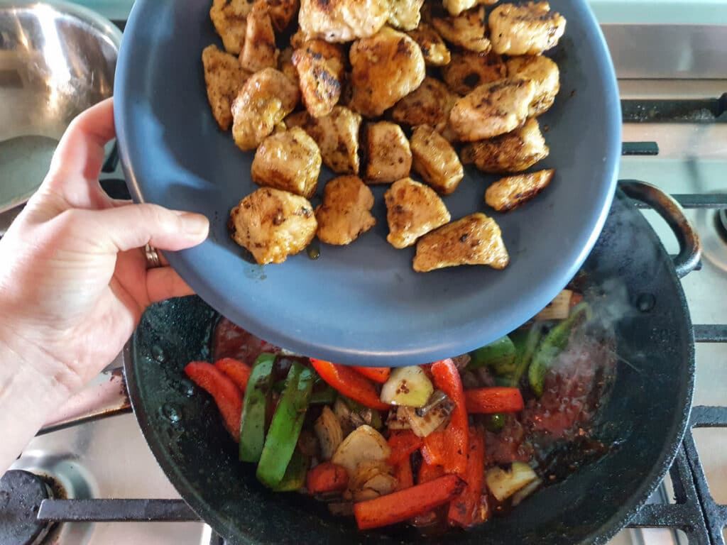 Adding cooked chicken back into gravy.