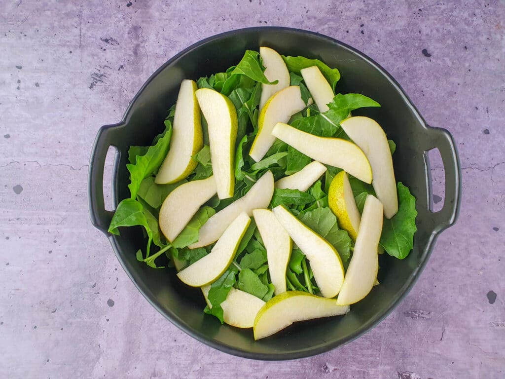 Building salad, adding lemony pears.
