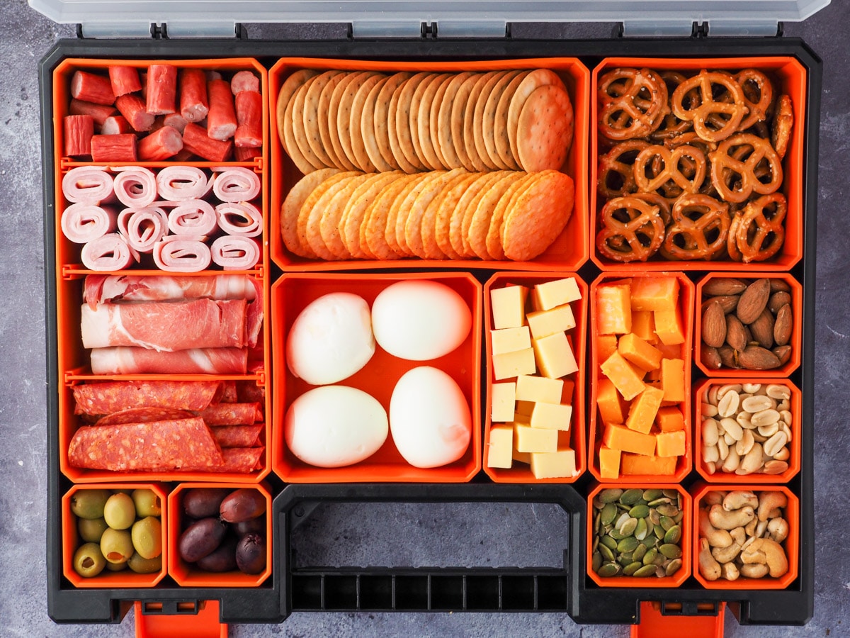 Picnic Charcuterie Board 9 Multi compartment container filled with various charcuterie food.