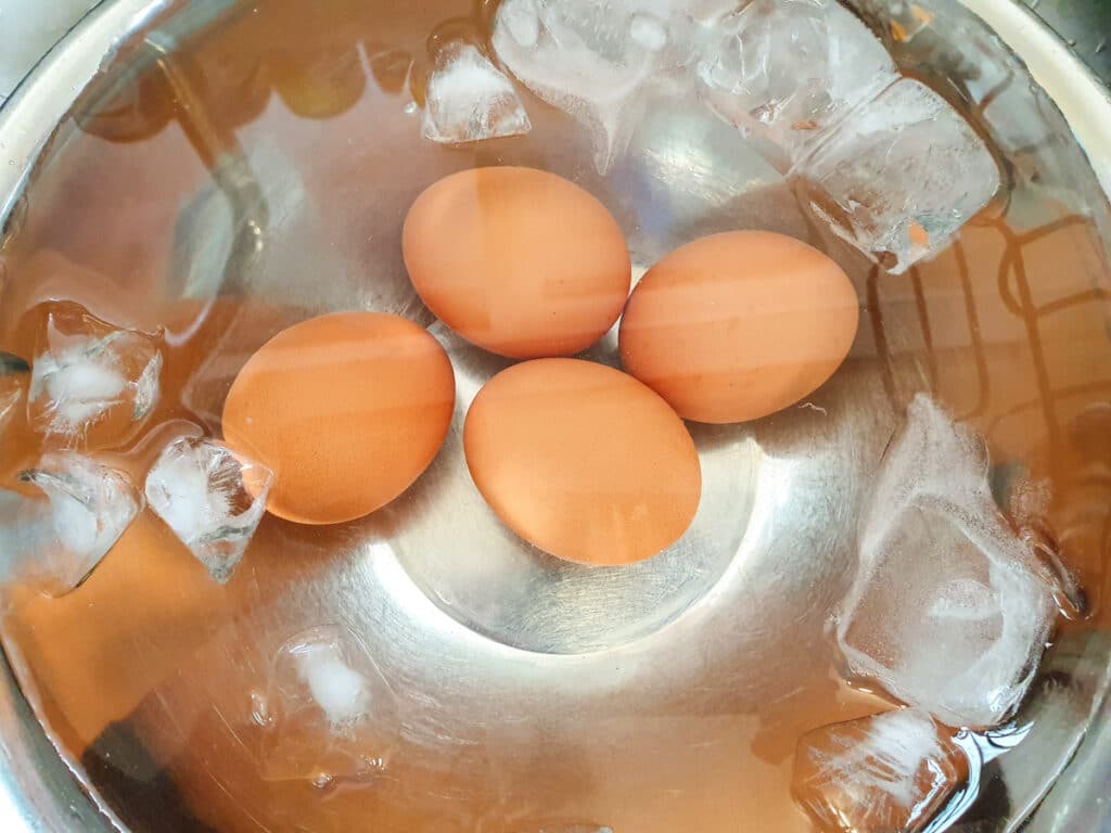 Picnic Charcuterie Board 4 Cooling cooked eggs in ice water.