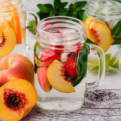 Peach Water 19 Peach infused water with strawberry and basil, with lime mint mixins and orange ginger mixins in background.