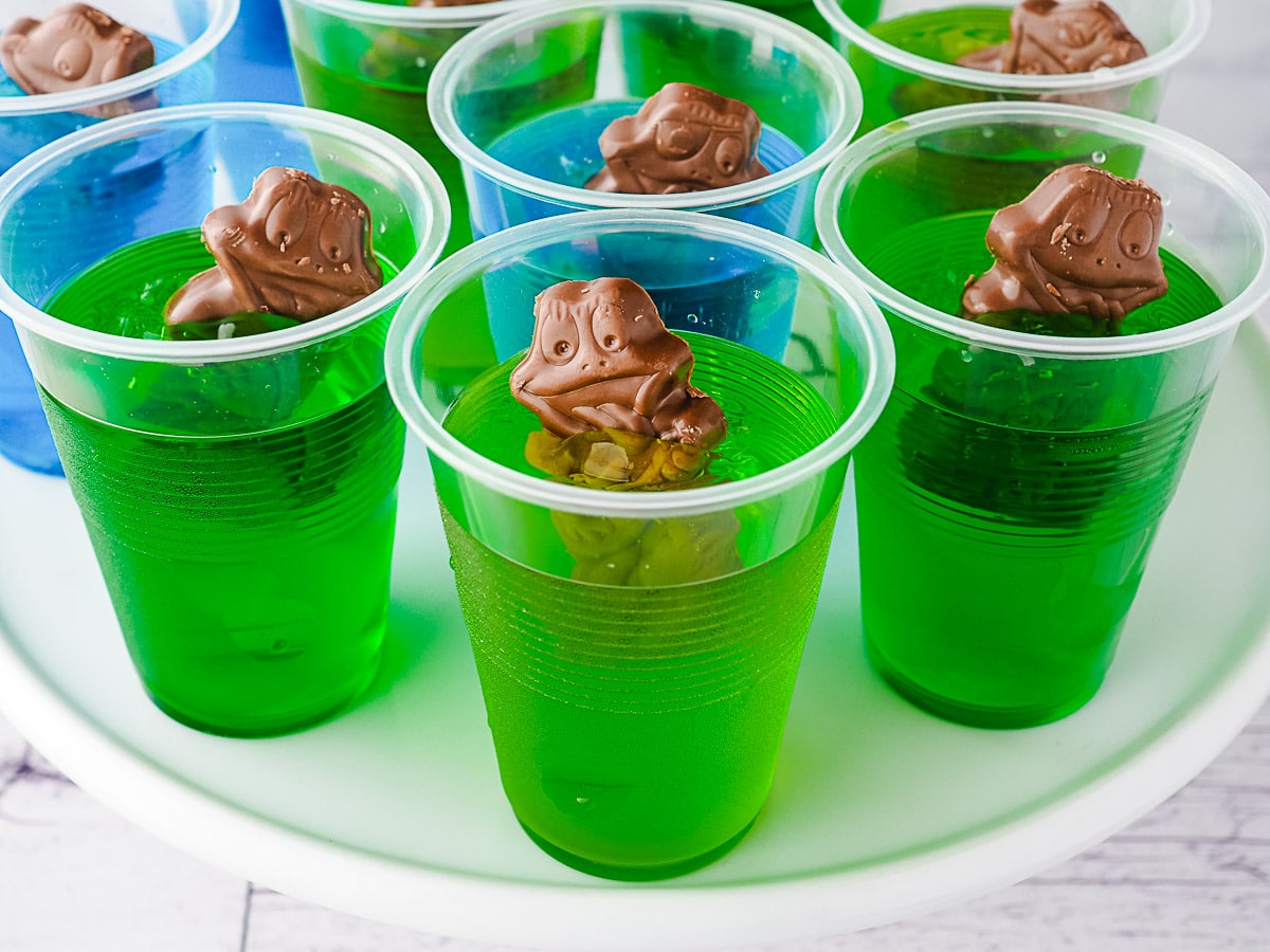 Several jelly cups on a plate.