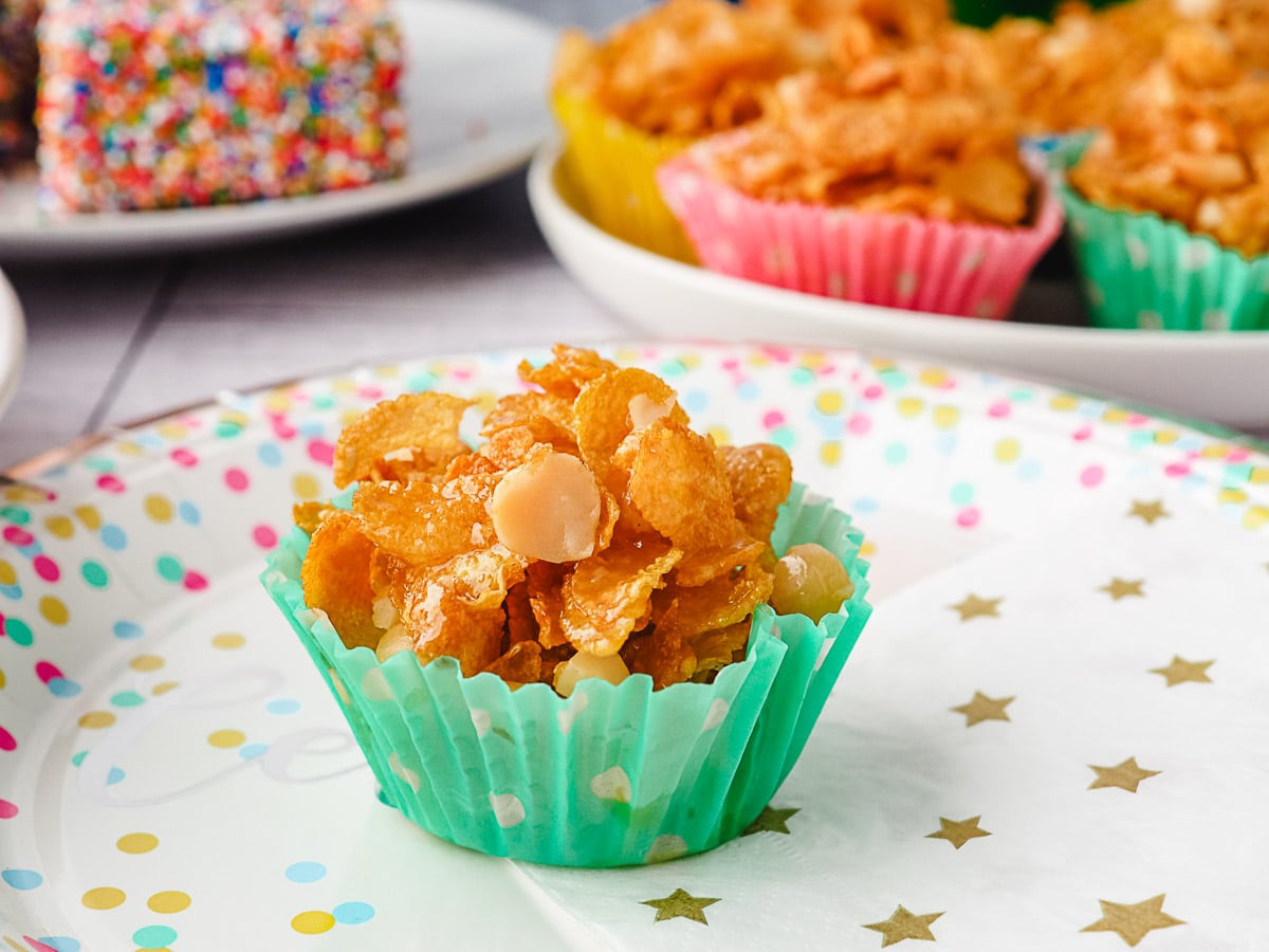 Honey joy on a plate with party food in background.