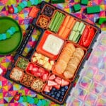 Kids Charcuterie Board 7 Charcuterie board on a picnic blanket with kids toys.