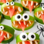 Apple Monsters 8 Close up apple monsters on a plate with toy spiders.