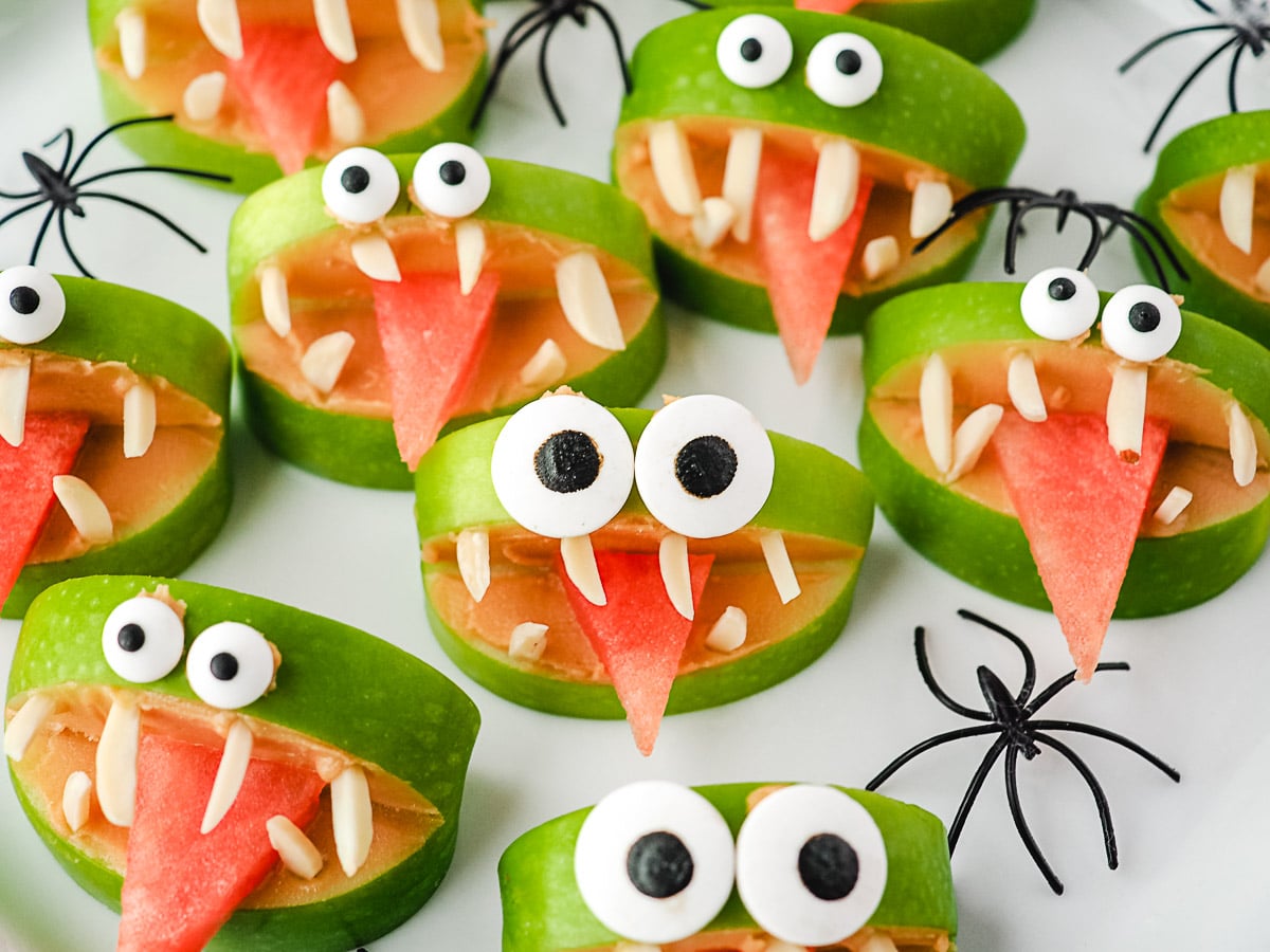 Apple Monsters 1 Close up apple monsters on a plate with toy spiders.