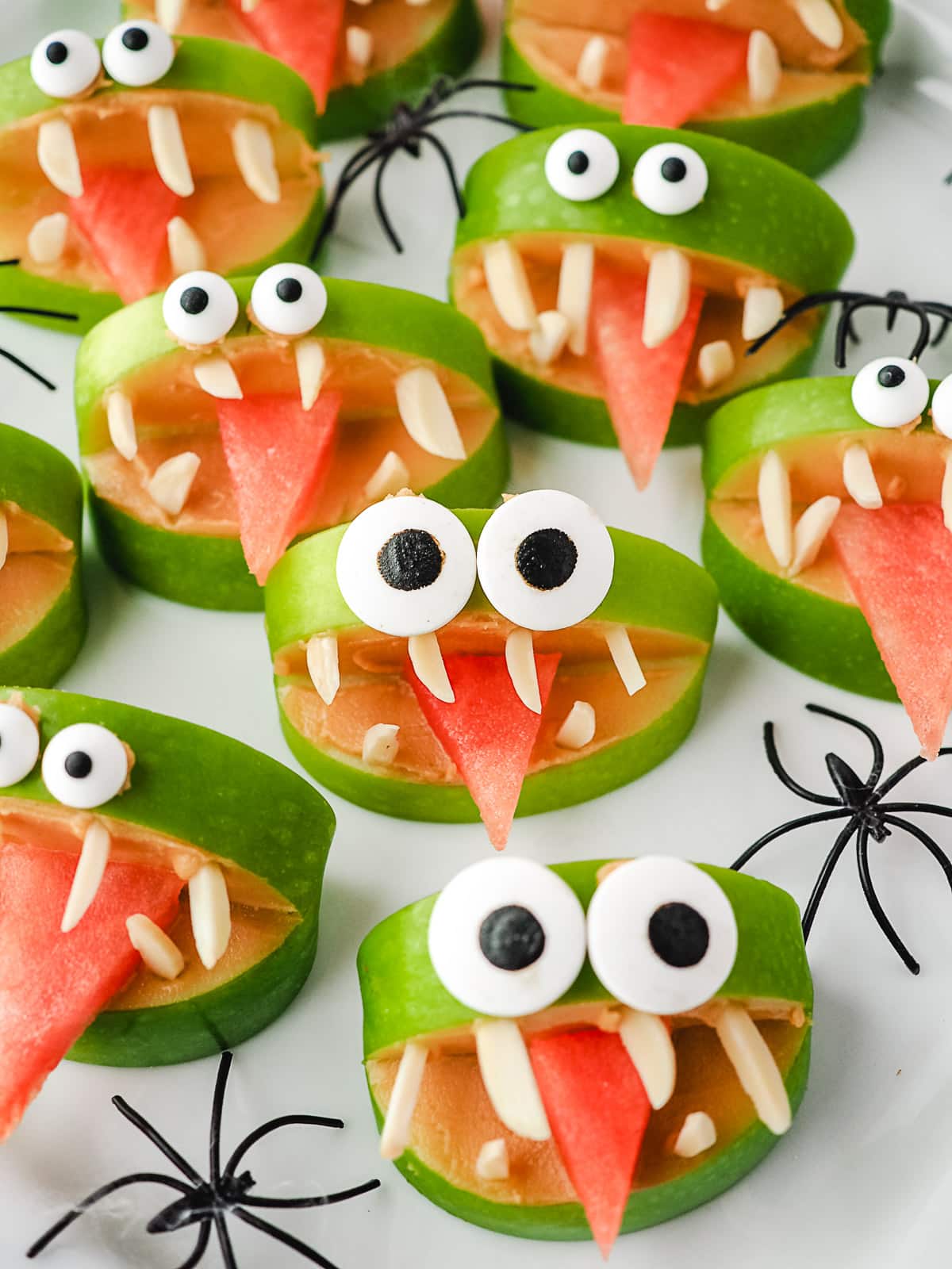 Apple Monsters 10 Apple monsters on a plate with toy spiders.