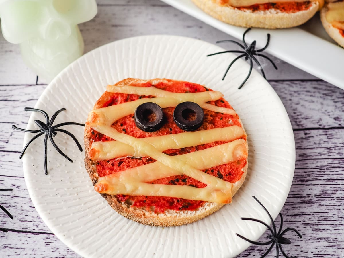 Mummy Pizzas 6 Pizza on a plate with Halloween spider decorations.