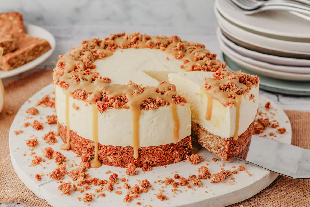 Taking a slice of Anzac cheesecake drizzled with golden syrup caramel.