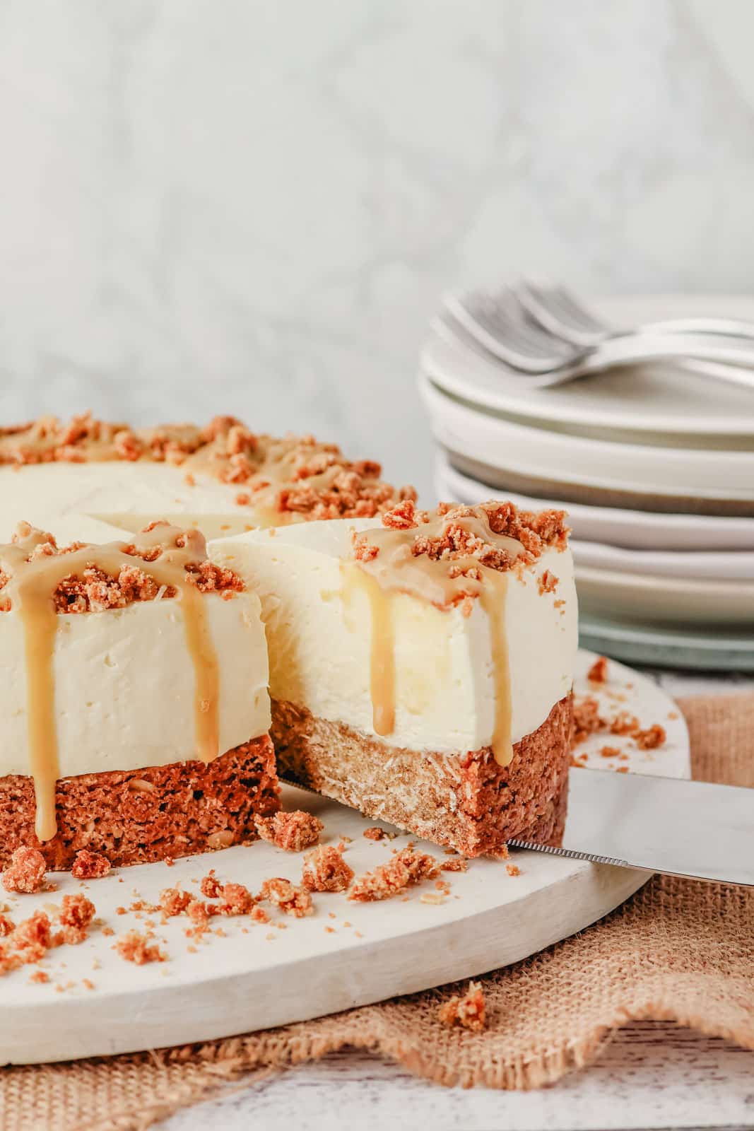 Taking a slice of Anzac cheesecake drizzled with golden syrup caramel.